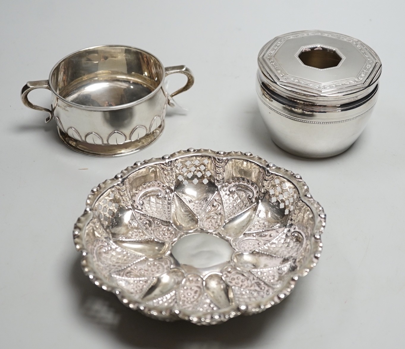 An Edwardian repousse silver shallow bowl, Birmingham, 1901, 16.1cm, together with a modern silver toilet jar and a 1920's silver two handled small bowl, 14.9oz.